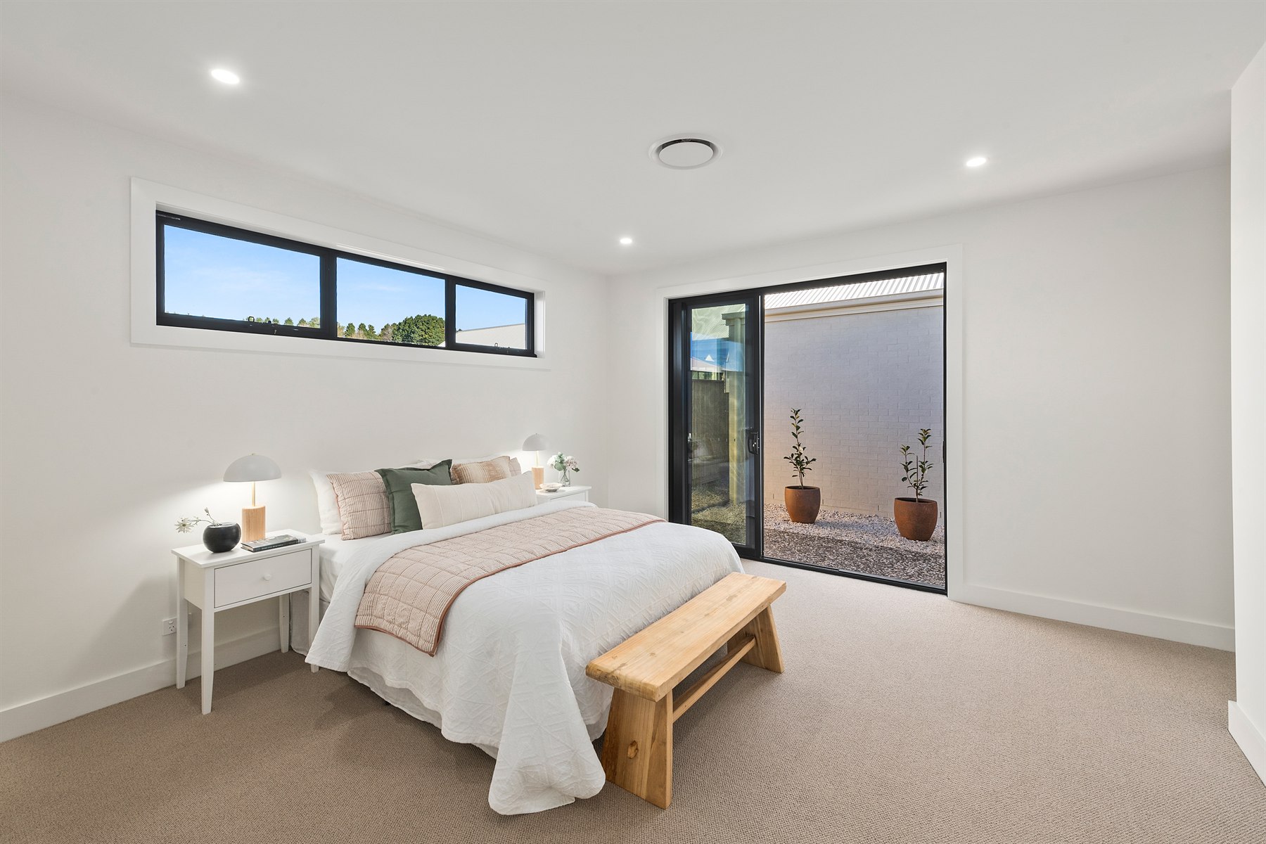 Completed bedroom with natural light and neutral finishes