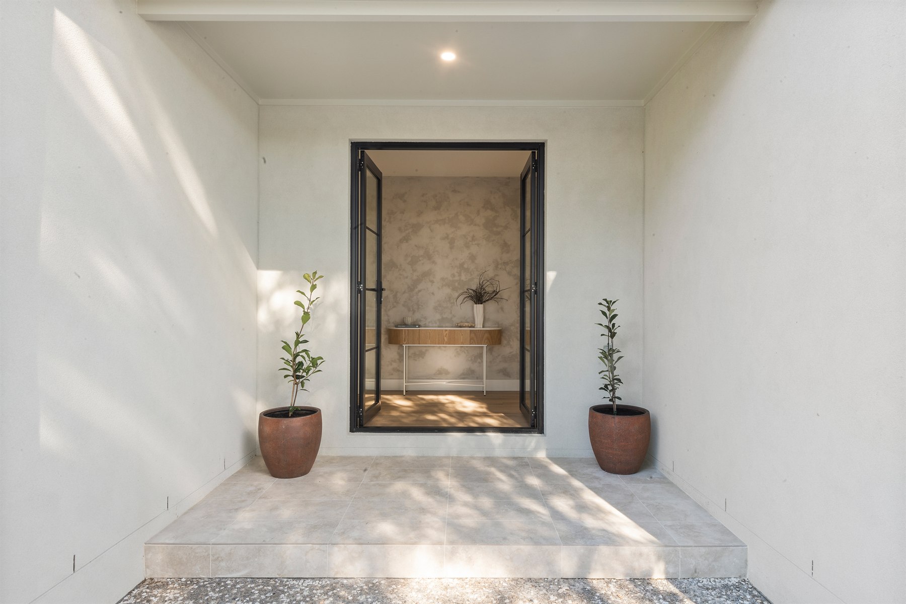 Covered entry with view through to finished bathroom